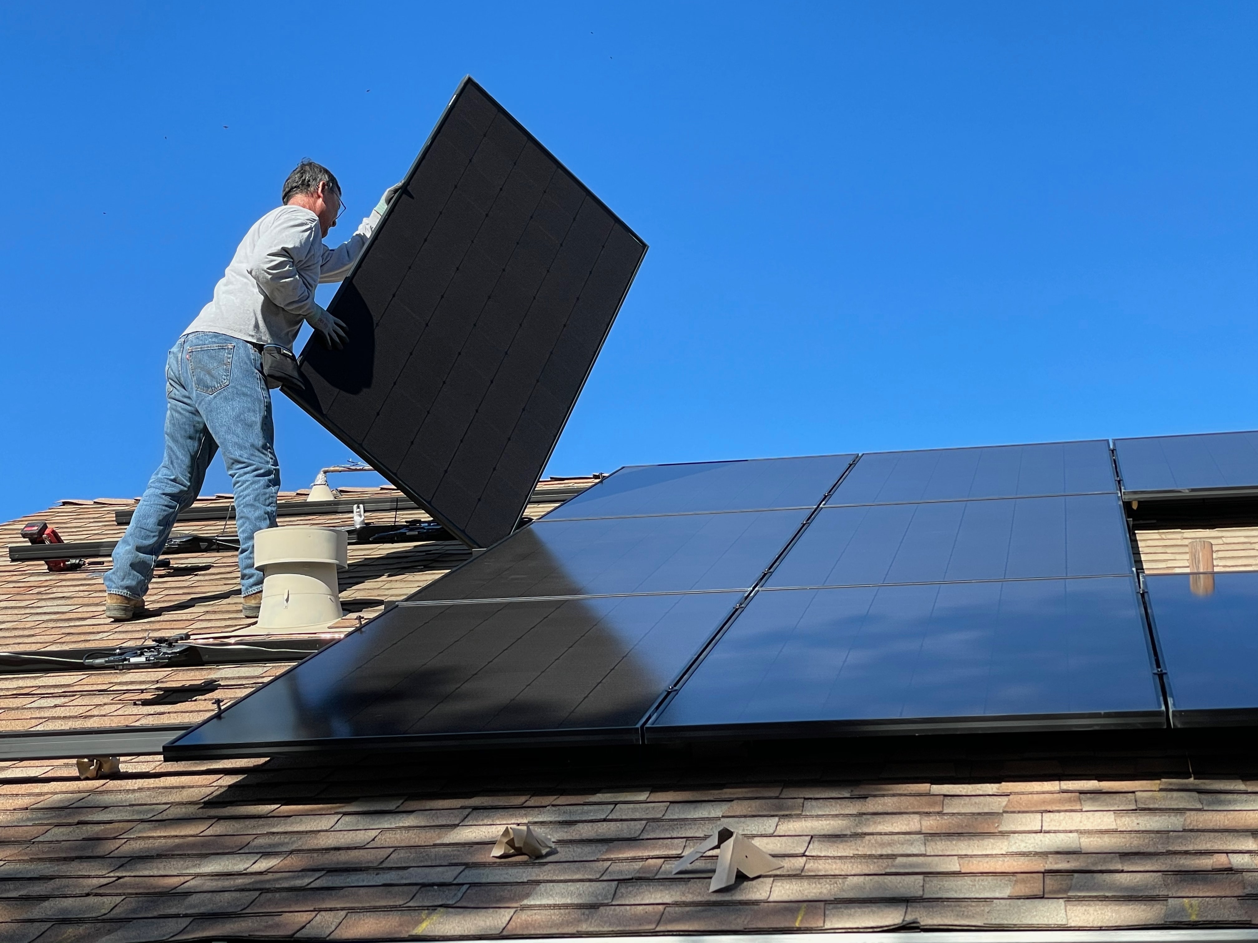 Man installing solar panels. Photo by Bill Mead on Unsplash