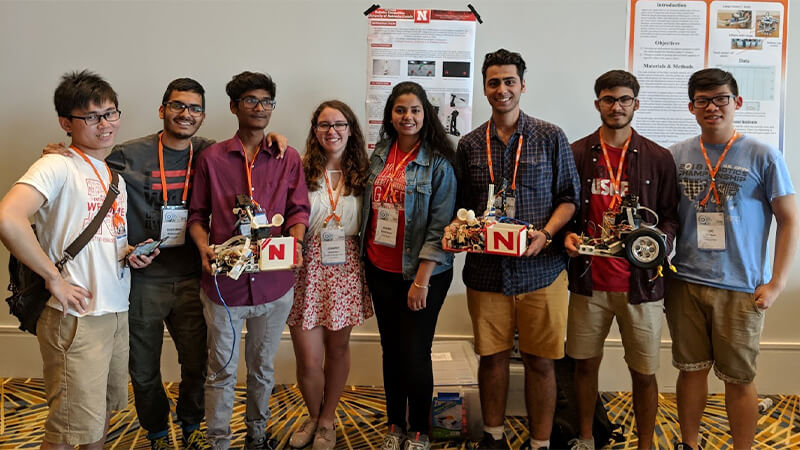 Students wearing medals after winning competition