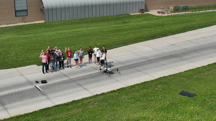Aerial image from a drone looking down on high school student campers on the track at the Nebraska Tractor Test Lab
