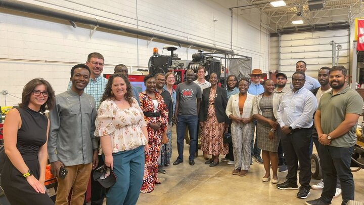 group of students, faculty, and dignitaries pose for a picture in the MAARS lab