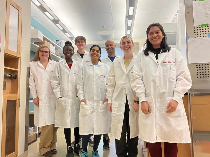 Photo of Iverson Lab members in white coats in the Lab